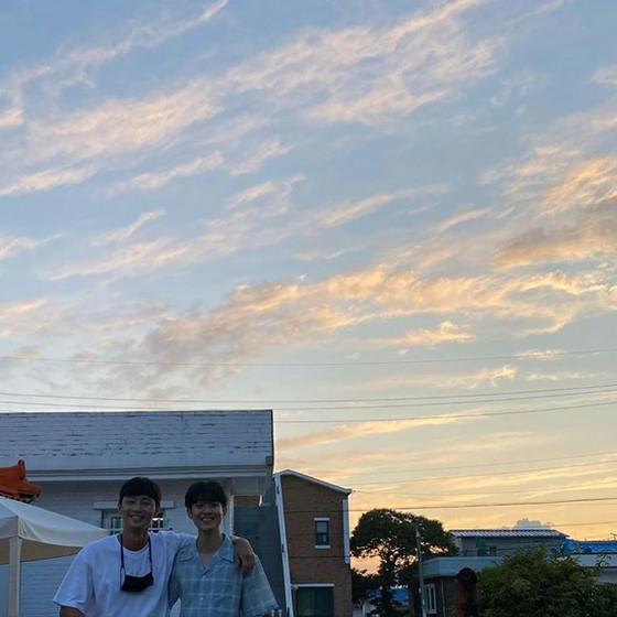 Choi Woo-shik with his best friend Park Seo Jun. Photo with the backdrop of the sunset...  Smiles that blows away the heat.