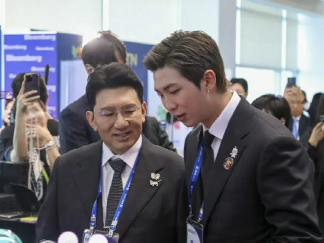 HYBE Chairman Bang Si Hyuk and RM (BTS) visit HYBE's promotional booth at the APEC CEO Summit
