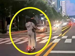 Couple riding electric scooters against the road causes controversy in South Korea