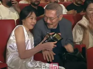 Kim Min Hee buries her face in Hong Sang Soo's arms as she wins the Locarno Best Actress Award