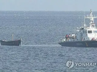 North Korean wooden boat discovered off the western coast of South Korea with two people aboard - possibly adrift