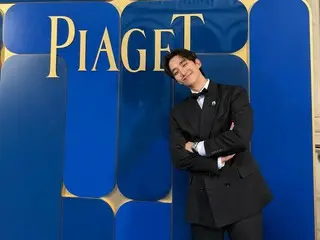 2PM's JUNHO, in a suit and with a mischievous smile
