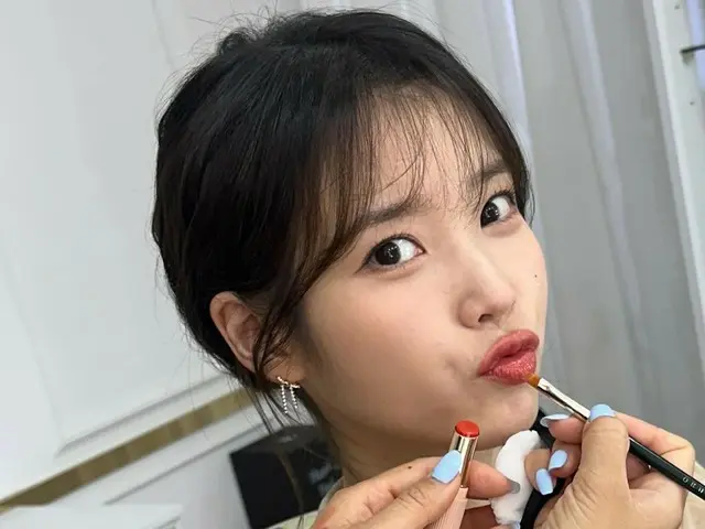 IU pouts her lips and exudes overwhelming cuteness