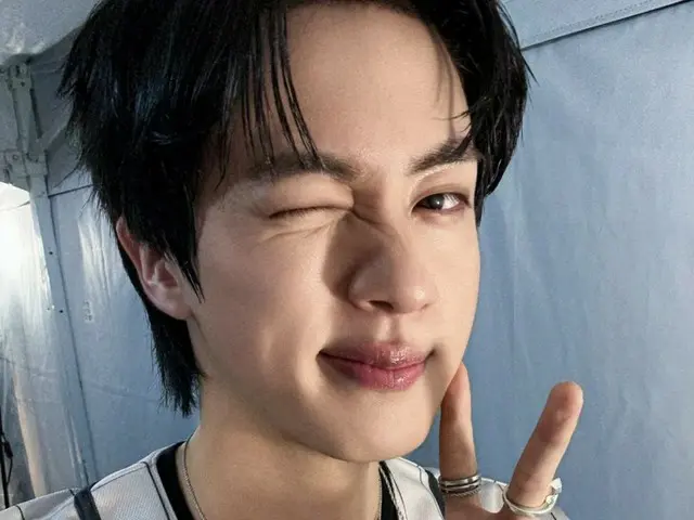 BTS' JIN gives a cute wink and peace sign... "Every moment spent laughing, jumping and singing is happy"